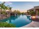 Beautiful backyard pool area featuring a rock waterfall, spa, and fire pit for outdoor entertaining at 26285 N 89Th St, Scottsdale, AZ 85255