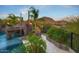 Gorgeous custom pool with rock waterfall, desert landscaping, and a pathway leading to a private oasis at 26285 N 89Th St, Scottsdale, AZ 85255