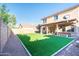 Manicured backyard featuring artificial turf and patio area at 2990 E Franklin Ave, Gilbert, AZ 85295