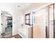 The bathroom has a shower with a glass door, a soaking tub, and a closet with a door in the background at 2990 E Franklin Ave, Gilbert, AZ 85295