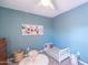 Cozy bedroom featuring a small bed, artwork, and plush decor at 2990 E Franklin Ave, Gilbert, AZ 85295