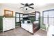 This bedroom has a bunk bed with a white dresser and two windows with a desk at 2990 E Franklin Ave, Gilbert, AZ 85295