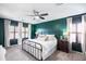 Bedroom featuring a cozy bed with many pillows, and two large windows with wooden shutters at 2990 E Franklin Ave, Gilbert, AZ 85295