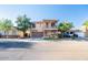 Inviting two-story home with a covered balcony, a two car garage, and desert landscaping at 2990 E Franklin Ave, Gilbert, AZ 85295