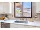 Bright kitchen features quartz countertops, gold faucet, tiled backsplash and a window at 2990 E Franklin Ave, Gilbert, AZ 85295