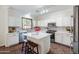 Modern kitchen with an island, stainless appliances, and white cabinetry at 2990 E Franklin Ave, Gilbert, AZ 85295