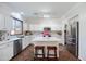 Modern kitchen with an island, stainless appliances, and tile backsplash at 2990 E Franklin Ave, Gilbert, AZ 85295