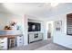 Bright and airy living space including a desk, mounted television, and neutral color palette at 2990 E Franklin Ave, Gilbert, AZ 85295