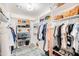 Organized walk-in closet with white shelving, hanging rods, baskets, and an area rug at 2990 E Franklin Ave, Gilbert, AZ 85295