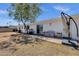 This backyard has a seating area, a grill, and partial shade from a mature tree at 3116 W Calavar Rd, Phoenix, AZ 85053