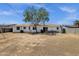 Wide backyard view showcasing the home's exterior, grill, and some seating at 3116 W Calavar Rd, Phoenix, AZ 85053