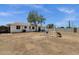 The spacious backyard features a tree and a swing set for outdoor fun at 3116 W Calavar Rd, Phoenix, AZ 85053
