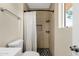 This modern bathroom has a shower with stylish tile and a patterned shower curtain at 3116 W Calavar Rd, Phoenix, AZ 85053