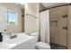This modern bathroom has a shower with stylish tile and a patterned shower curtain at 3116 W Calavar Rd, Phoenix, AZ 85053