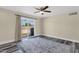Bright bedroom featuring wood-look floors, neutral walls, and sliding glass doors to the backyard at 3116 W Calavar Rd, Phoenix, AZ 85053