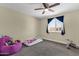 Bedroom featuring a ceiling fan and ample light with an inviting purple beanbag at 3116 W Calavar Rd, Phoenix, AZ 85053