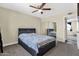 Bedroom with a ceiling fan, mirrored closet doors, and ensuite bath access at 3116 W Calavar Rd, Phoenix, AZ 85053