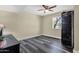 This bedroom includes vinyl floors, a ceiling fan, and a window to provide natural light at 3116 W Calavar Rd, Phoenix, AZ 85053