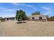 Inviting single-story home with desert landscaping, and a lush green tree in the front yard at 3116 W Calavar Rd, Phoenix, AZ 85053