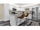 Modern kitchen featuring white cabinets, stainless steel appliances, and a center island with seating at 3116 W Calavar Rd, Phoenix, AZ 85053