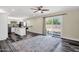 Bright and open living room with wood-look floors, a large sliding door, and modern fixtures at 3116 W Calavar Rd, Phoenix, AZ 85053