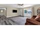 Comfortable living room featuring a decorative rug, wood-look floors, and natural light at 3116 W Calavar Rd, Phoenix, AZ 85053