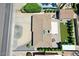 Aerial view of a home with a spacious backyard, well manicured landscaping, and a detached garage at 3505 N Miller Rd, Scottsdale, AZ 85251