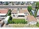 Aerial view of a home with a covered patio, detached garage, and astroturf yard at 3505 N Miller Rd, Scottsdale, AZ 85251