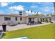 Relaxing backyard featuring artificial grass, a covered patio, and desert landscaping at 3505 N Miller Rd, Scottsdale, AZ 85251
