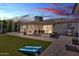 Spacious backyard featuring an artificial lawn, covered patio and outdoor dining set at 3505 N Miller Rd, Scottsdale, AZ 85251