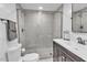 Modern bathroom features a glass-enclosed shower with sleek gray tiling and a contemporary vanity at 3505 N Miller Rd, Scottsdale, AZ 85251