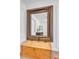 Ornate framed mirror over wooden chest adds vintage charm and enhances this bedroom's character at 3505 N Miller Rd, Scottsdale, AZ 85251