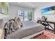 Bright bedroom with a large window, a comfortable bed, and a view that adds to the peaceful ambiance at 3505 N Miller Rd, Scottsdale, AZ 85251
