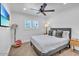 Comfortable bedroom features a queen bed, ceiling fan, and a mounted TV, perfect for relaxation at 3505 N Miller Rd, Scottsdale, AZ 85251