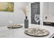 Stylish dining area with decorative plates, elegant glasses, and a modern aesthetic for refined meals at 3505 N Miller Rd, Scottsdale, AZ 85251