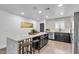 Modern kitchen with a large quartz countertop island, stainless steel appliances, and breakfast bar seating at 3505 N Miller Rd, Scottsdale, AZ 85251