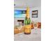 Staged kitchen scene featuring a bottle of champagne, stemware, and a view of the living room at 3505 N Miller Rd, Scottsdale, AZ 85251