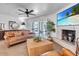 Cozy living room with modern decor, brick fireplace, and entertainment center at 3505 N Miller Rd, Scottsdale, AZ 85251