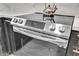 Close up of the stainless steel oven and stove top featuring modern touch screen controls at 3505 N Miller Rd, Scottsdale, AZ 85251