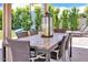 Covered patio with dining table, wicker chairs, and a lantern, ideal for outdoor entertaining at 3505 N Miller Rd, Scottsdale, AZ 85251