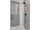 Modern shower with gray tiling, glass door, and mosaic accents, combining style and functionality at 3505 N Miller Rd, Scottsdale, AZ 85251