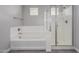 Bright bathroom featuring a bathtub and separate shower with glass doors and modern fixtures at 3710 E Cheery Lynn Rd, Phoenix, AZ 85018