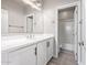 Modern bathroom featuring white cabinets, countertop, and a large mirror, complemented by sleek fixtures at 3710 E Cheery Lynn Rd, Phoenix, AZ 85018