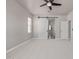 Neutral bedroom showcasing a sliding barn door, a ceiling fan, and a large window at 3710 E Cheery Lynn Rd, Phoenix, AZ 85018