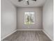 Neutral bedroom with wood-look tile flooring, a window with blinds, and a ceiling fan at 3710 E Cheery Lynn Rd, Phoenix, AZ 85018