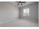 Well-lit bedroom with a ceiling fan, a large window, and soft carpet, creating a relaxing atmosphere at 3710 E Cheery Lynn Rd, Phoenix, AZ 85018