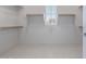 Walk-in closet with built-in shelving and a window for natural light, providing ample storage at 3710 E Cheery Lynn Rd, Phoenix, AZ 85018