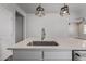 Close up of the kitchen island featuring quartz countertop and stainless steel sink and faucet at 3710 E Cheery Lynn Rd, Phoenix, AZ 85018
