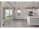 Bright kitchen with stainless steel appliances, white cabinets, and sliding glass doors to the backyard at 3710 E Cheery Lynn Rd, Phoenix, AZ 85018