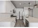 Modern kitchen with white cabinetry, stainless steel appliances, and a spacious island with bar seating at 3710 E Cheery Lynn Rd, Phoenix, AZ 85018